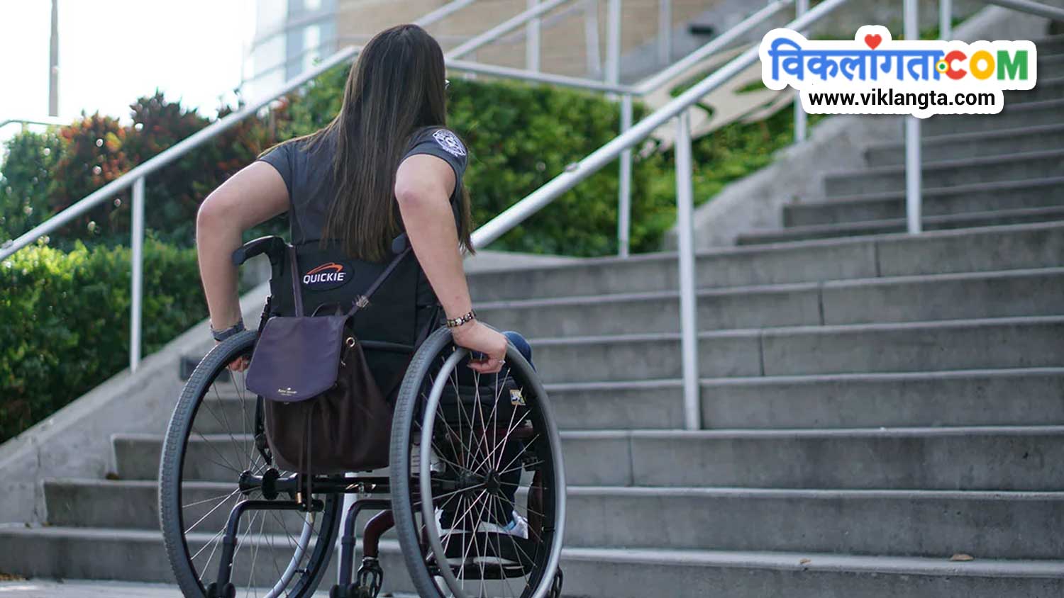 woman in wheelchair in front of inaccessible steps