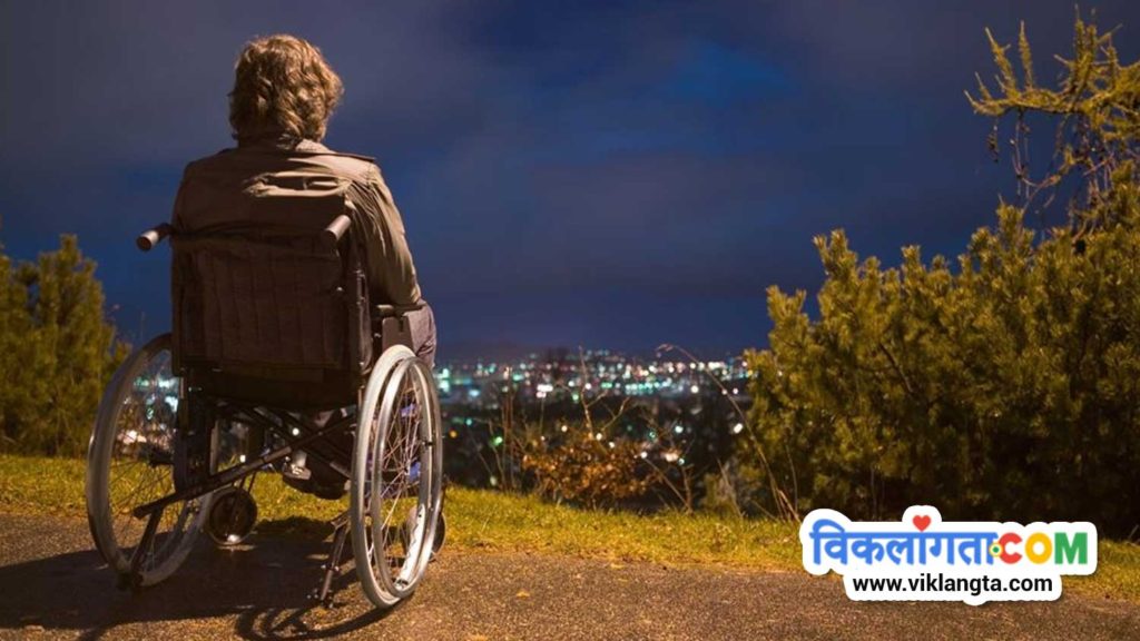 a wheelchair user man sitting on a roadside alone in night